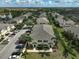 Aerial view of townhomes featuring ample parking, sidewalks, and green spaces near a lake at 233 Cape Harbour Loop # 107, Bradenton, FL 34212
