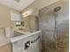 Modern bathroom with double sinks, mirror, modern lighting, and walk-in shower at 241 Marcheno Way, Nokomis, FL 34275