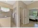 Spacious bathroom featuring a tiled shower, toilet, and an entry into the bedroom at 241 Marcheno Way, Nokomis, FL 34275