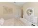 Comfortable bedroom features neutral decor, closet, and a charming dresser with decorative accents at 241 Marcheno Way, Nokomis, FL 34275