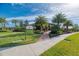A gorgeous clubhouse welcomes you with lush landscaping and well-maintained walkway at 241 Marcheno Way, Nokomis, FL 34275