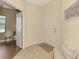 Bright foyer featuring tile flooring, a white front door, and an open doorway to the living area at 241 Marcheno Way, Nokomis, FL 34275