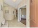 Inviting foyer with tile flooring, view of living room, and entry to dining area for a welcoming entrance at 241 Marcheno Way, Nokomis, FL 34275