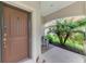 Inviting front porch with seating area near the entry door at 241 Marcheno Way, Nokomis, FL 34275