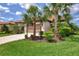 Charming single-story home with a two-car garage, terracotta roof, and mature landscaping at 241 Marcheno Way, Nokomis, FL 34275