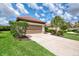 Charming single-story home with a two-car garage, terracotta roof, and mature landscaping at 241 Marcheno Way, Nokomis, FL 34275