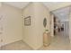 Neutral hallway with a view into the dining area and kitchen with tile flooring for easy maintenance at 241 Marcheno Way, Nokomis, FL 34275