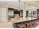 A stunning kitchen with large granite island, stainless steel appliances and custom cabinetry at 241 Marcheno Way, Nokomis, FL 34275