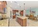 Updated kitchen features a large island, stainless steel appliances, and a view of the adjacent dining area at 241 Marcheno Way, Nokomis, FL 34275