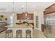 Spacious kitchen with a central island, granite countertops, and modern appliances, perfect for cooking at 241 Marcheno Way, Nokomis, FL 34275