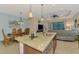 Open kitchen concept featuring a granite countertop island, stainless steel sink, and seamless flow to living spaces at 241 Marcheno Way, Nokomis, FL 34275