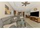 Open-concept living space showcasing a large sectional, kitchen with bar seating, and dining area at 241 Marcheno Way, Nokomis, FL 34275
