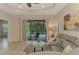 Inviting living room boasts a plush sofa, glass coffee table, and access to a screened lanai at 241 Marcheno Way, Nokomis, FL 34275