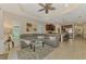 Spacious living room featuring an open layout, large sectional sofa, and seamless flow to kitchen at 241 Marcheno Way, Nokomis, FL 34275