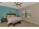 Spacious main bedroom with a queen size bed, two side tables, and bench with natural light coming in at 241 Marcheno Way, Nokomis, FL 34275