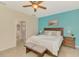Comfortable main bedroom with a queen size bed and matching side tables with a bathroom view at 241 Marcheno Way, Nokomis, FL 34275