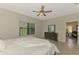 Bright main bedroom featuring a large window, dresser, and a cozy bed at 241 Marcheno Way, Nokomis, FL 34275