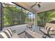 Screened-in lanai with comfortable seating overlooking lush tropical landscaping for privacy at 241 Marcheno Way, Nokomis, FL 34275