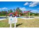 Outdoor community park featuring a fun playground, picnic tables, and shelter under a sunny blue sky with fluffy white clouds at 241 Marcheno Way, Nokomis, FL 34275