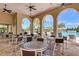 Outdoor dining by the pool offers a refreshing and delightful experience with ample seating at 241 Marcheno Way, Nokomis, FL 34275