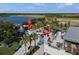 An aerial view of community lakeside retail space with casual outdoor seating and walking paths at 2424 Affinity Ln, North Port, FL 34286