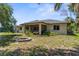 Spacious backyard featuring a screened patio, fire pit, and landscaped borders at 2424 Affinity Ln, North Port, FL 34286