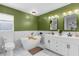Stylish bathroom featuring a soaking tub, modern vanity, and a green accent wall at 2424 Affinity Ln, North Port, FL 34286