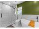 Bright bathroom features a glass shower, freestanding tub, and stylish tile work at 2424 Affinity Ln, North Port, FL 34286