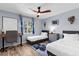 Bright bedroom with two twin beds, a desk, and large window at 2424 Affinity Ln, North Port, FL 34286