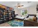 Cozy bedroom with twin beds, ceiling fan, and a window offering natural light at 2424 Affinity Ln, North Port, FL 34286