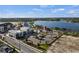 Aerial view of a community center with modern amenities, parking, and landscaping near a serene lake at 2424 Affinity Ln, North Port, FL 34286