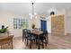 Bright dining room with contemporary chandelier, modern furniture, and a decorative cobalt blue front door at 2424 Affinity Ln, North Port, FL 34286