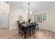 Dining room with modern chandelier lighting, contemporary furniture, and a large window for ample natural light at 2424 Affinity Ln, North Port, FL 34286