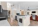Bright kitchen featuring an open layout with breakfast bar, sleek counter tops, and stainless-steel appliances at 2424 Affinity Ln, North Port, FL 34286