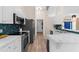 Bright kitchen with white cabinetry, stainless steel appliances, modern countertop, and eye-catching backsplash at 2424 Affinity Ln, North Port, FL 34286