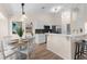 Eat-in kitchen area with modern decor, stainless steel appliances, a peninsula countertop, and a dining area at 2424 Affinity Ln, North Port, FL 34286