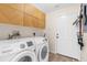 Modern laundry room with front-loading machines and plenty of cabinet space at 2424 Affinity Ln, North Port, FL 34286