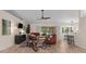 Cozy living room featuring sleek floors, modern fan, stylish furnishings, and access to the outdoors at 2424 Affinity Ln, North Port, FL 34286