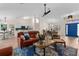 Open living space with modern furnishings, bright light, and seamless flow from the kitchen to the dining area at 2424 Affinity Ln, North Port, FL 34286