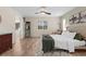 Bright main bedroom with a ceiling fan, view to the yard, and a decorative accent wall at 2424 Affinity Ln, North Port, FL 34286