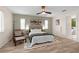 Cozy main bedroom featuring a ceiling fan, natural light, and an en-suite bathroom at 2424 Affinity Ln, North Port, FL 34286