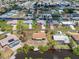 Aerial view of the home and backyard with boat dock, surrounded by lush landscaping at 2618 Titania Rd, Englewood, FL 34224