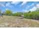 The home's backyard features lush greenery and potential for outdoor activities and relaxation at 2618 Titania Rd, Englewood, FL 34224
