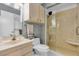 Bathroom featuring a glass enclosed shower, vanity, and toilet at 2618 Titania Rd, Englewood, FL 34224