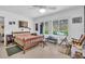 Spacious bedroom with tiled floors, a ceiling fan, and a sunny window at 2618 Titania Rd, Englewood, FL 34224