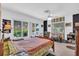 Sun-lit bedroom featuring tiled floors and a light color palette at 2618 Titania Rd, Englewood, FL 34224