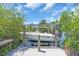 Image showing a Key West boat on a lift surrounded by lush mangroves and a wooden dock at 2618 Titania Rd, Englewood, FL 34224