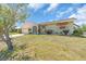 Single-story home featuring an attached garage, mature landscaping, and a well-kept lawn at 2618 Titania Rd, Englewood, FL 34224