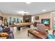 Spacious living room featuring tile floors, a fireplace and pool table under cover at 2618 Titania Rd, Englewood, FL 34224