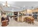 Open concept kitchen and living room featuring an entertainment area and breakfast bar at 2618 Titania Rd, Englewood, FL 34224